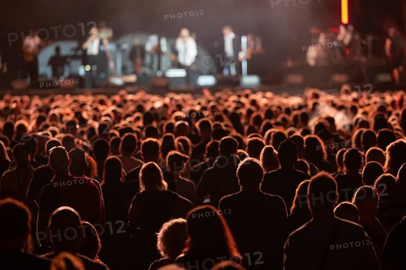Crowd of people in front of the stage during the concert.