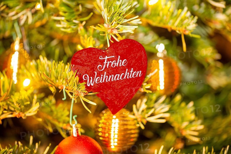 Christmas greetings: Heart with the inscription FROHE WEIHNACHTEN on a Christmas tree