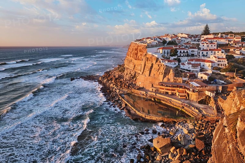 Scenic view of the seaside Azenhas do Mar fishing village on cliff on Atlantic ocean coast, Portugal on sunset