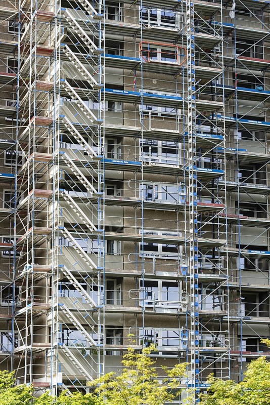 Scaffolded high-rise residential building with balconies and satellite dishes, Trabantenstadt Chorweiler in Cologne, North Rhine-Westphalia, Germany, Europe