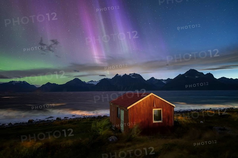 Northern Lights over a hut at the Lyngenfjord, Lyngen Alps, Lyngen, Troms og Finnmark, Norway, Europe