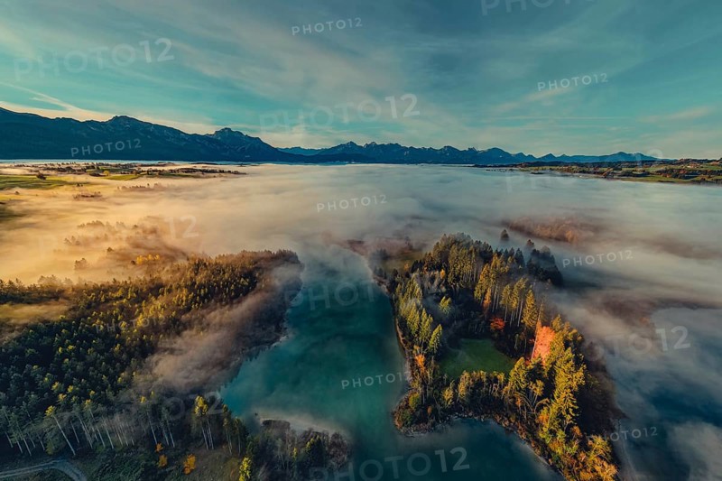 Autumn sunrise in the foothills of the Alps with fog at Illasbergsee and Forggensee near Halblech in Allgäu, Bavaria, Germany, Europe