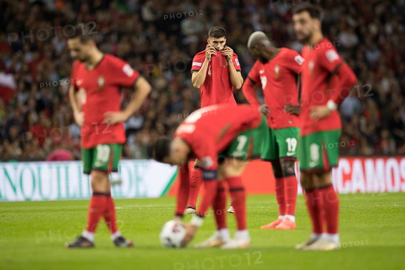 Football match, captain Cristiano RONALDO CR7 Portugal out of focus centre bent forward preparing the ball for a free kick, four Portuguese players in the background, sequence 9, Estadio do Dragao, Porto, Portugal, Europe