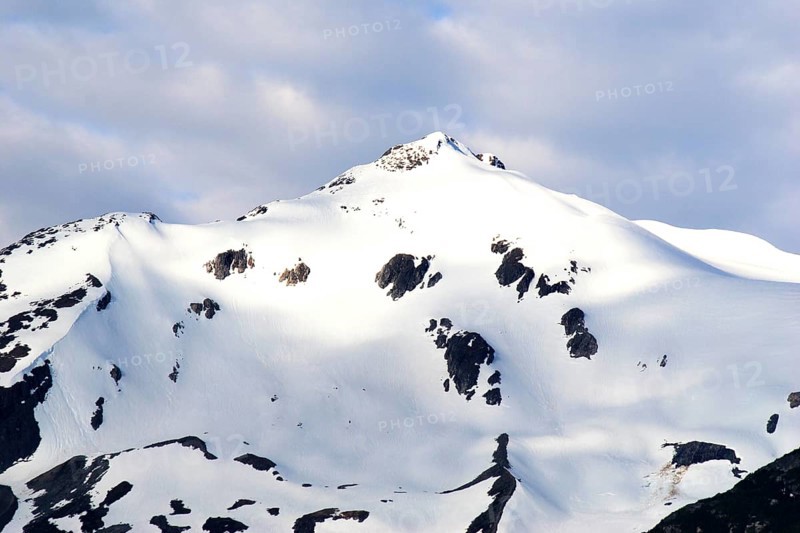 Snow capped mountains, A steel bridge constructed in 1901, tallest cantilever bridge in the world used until 1969, Skagway, Alaska, U.S.A. United States of America