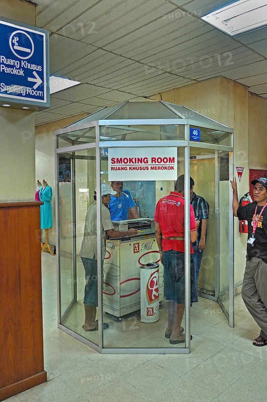 Smoking room with smoking locals, airport, Denpasar, Bali, Indonesia, Asia