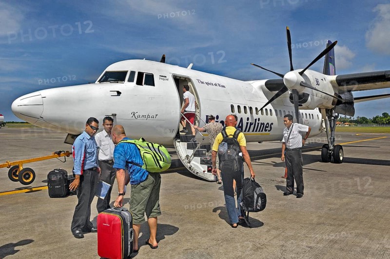 Propeller aircraft, prop jet Fokker 50, former Riau Airlines, passengers and staff at the airport in Labuan Bajo, Flores Island, Indonesia, Asia