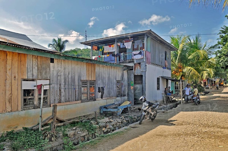 Side street with colourful laundry and locals in Labuan Bajo, Flores Island, Indonesia, Asia
