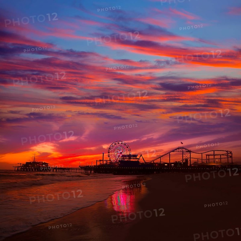 Santa Monica California sunset on Pier Ferrys wheel and reflection on beach wet sand