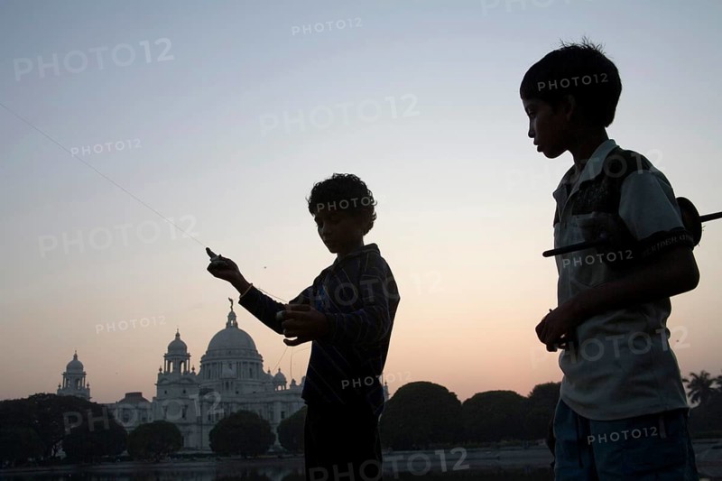 Children flying kite near at Victoria memorial impressive reminder of British Raj built between 1906 and 192, Calcutta now Kolkata, West Bengal, India, Asia