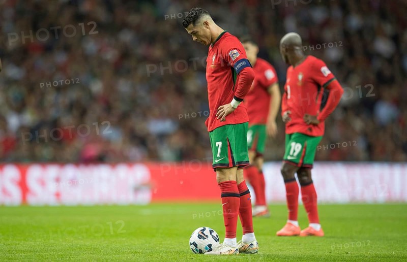 Football match, Cristiano RONALDO CR7 Portugal stands in front of the ball looking down with his head and focussing on the upcoming free kick, Estadio do Dragao, Porto, Portugal, sequence 10, Europe