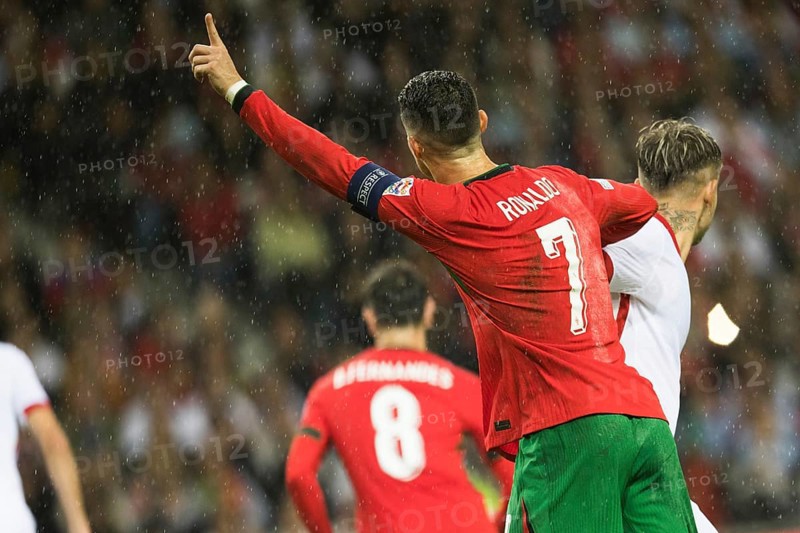 Football match, captain Cristiano RONALDO CR7 Portugal looking from behind in the rain, with outstretched left index finger pointing upwards, captain's armband, back number seven with RONALDO lettering, Estadio do Dragao, Porto, Portugal, Europe