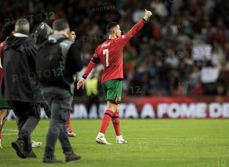 Football match, captain Cristiano RONALDO CR7 Portugal looks after the end of the match and victory right satisfied into the crowd with right raised arm and thumbs up, back number 7 and captain armband to see, a camera team follows and covers him from behind, Estadio do Dragao, Porto, Portugal, Europe