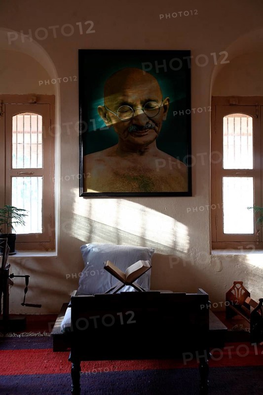 Mahatma Gandhi sitting place with his large photograph and his charkha at Satyagraha Ashram founded in 25-May-1915 at Kochrab