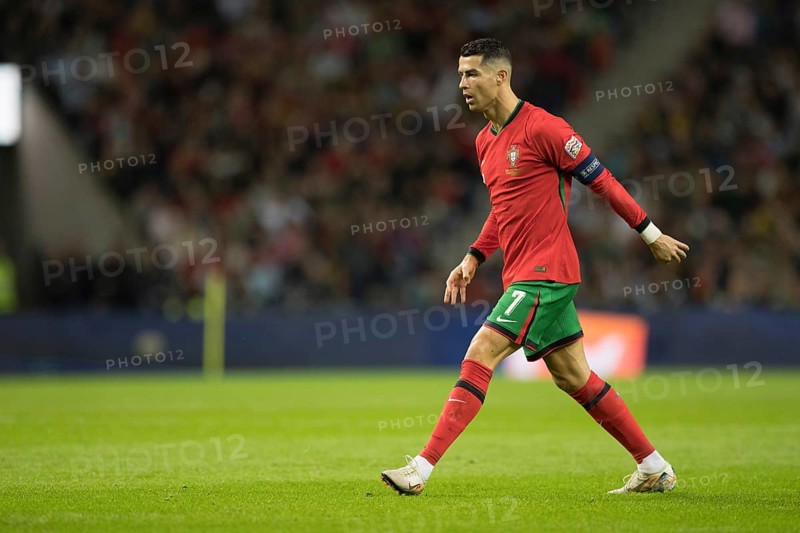 Football match, captain Cristiano RONALDO CR7 Portugal in front of the free kick with closed eyes, right leg stretched backwards, left leg stretched forwards and foot pointing upwards with captain's armband, he slowly takes a shot on goal, sequence 17, Estadio do Dragao, Porto, Portugal, Europe