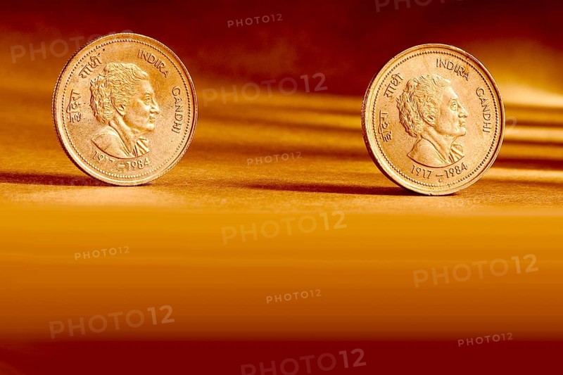 Double pair Indian currency five rupees coin front side and backside manner embossed Indira Gandhi 1917-1984 on orange background