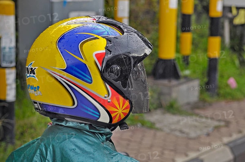 Brightly coloured motorbike shirt in the rain near Ubud, Bali, Indonesia, Asia