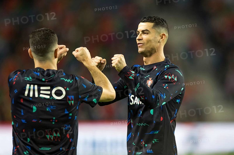 Football match, Cristiano RONALDO CR7 Portugal right, warming up in front of the match with matching grimace and fists pointing upwards just in front of fist bump with teammate looking to the left, Estadio do Dragao, Porto, Portugal, Europe