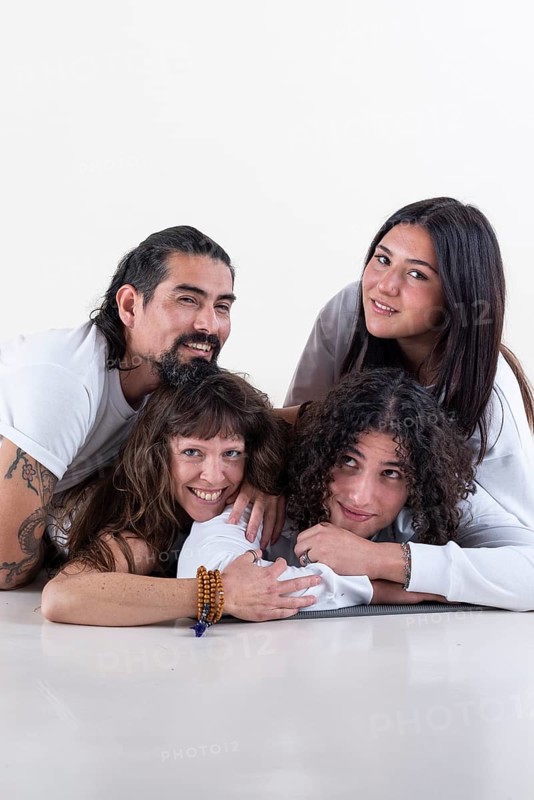Portrait of a group of yoga friends all looking at camera over white background. Studio shot. Copy Space