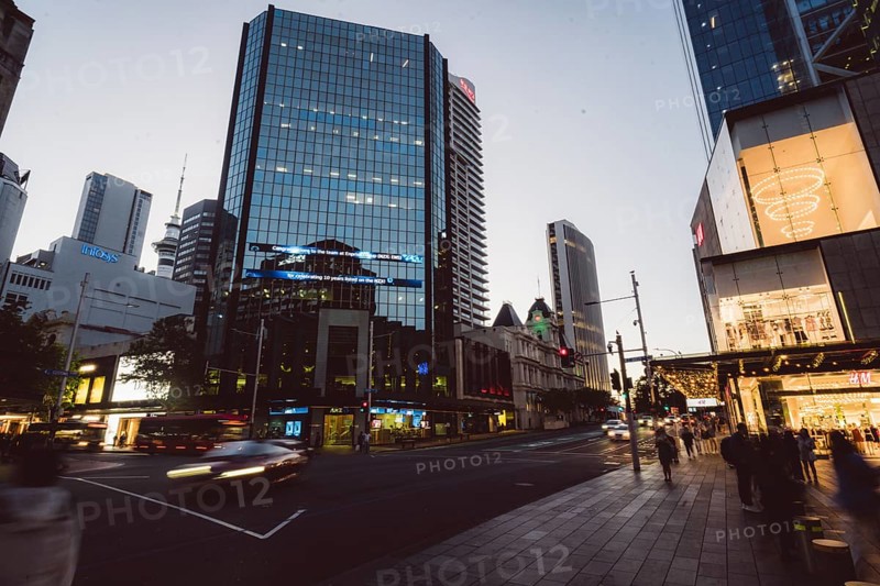 View of a busy street scene with modern skyscrapers and passers-by at dusk, new Zealand stock exchange, Auckland, New Zealand, Oceania