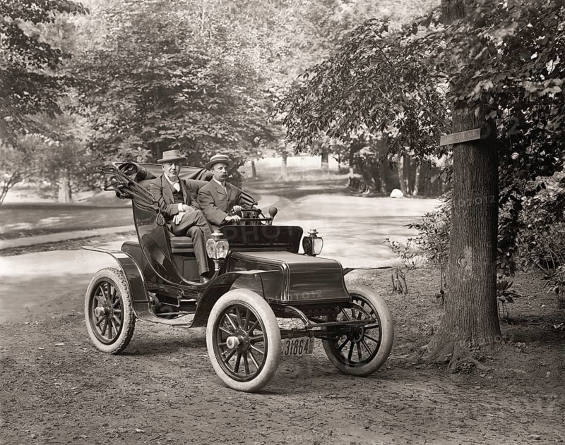 Thomas Alva Edison and William Billy Bee in Detroit Electric automobile on Edge Hill Avenue in Llewellyn Park, 1911, digitally edited