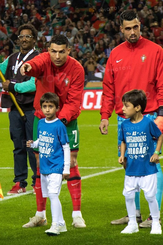 Football match, Cristiano RONALDO CR7 Portugal left, immediately after the national anthem of Portugal, pointing with his index finger in which direction he should leave the pitch, next to Diogo COSTA Portugal also with the child in front of the match, Estadio do Dragao, Porto, Portugal, Europe