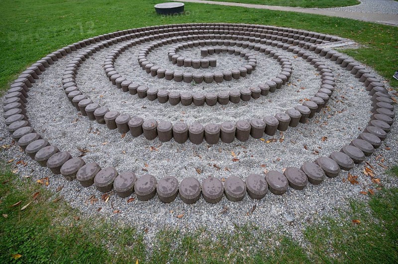 Built snail made of stones in front of the fortress walls of Dinkelsbühl, Bavaria, Germany, Europe