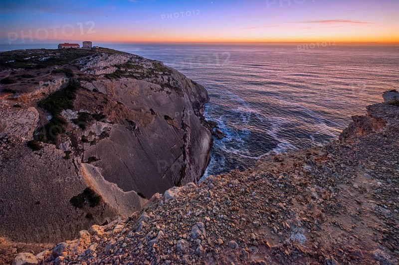 Cabo Espichel cape Espichel on Atlantic ocean at sunset with ruins
