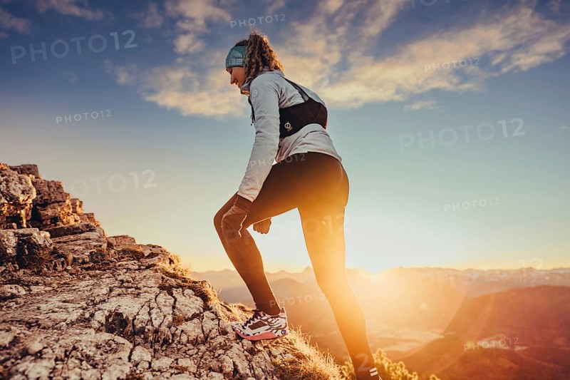 Trail running in autumn on the Jochberg on Lake Walchensee against the wonderful backdrop of the Alps, Bavaria, Germany, Europe