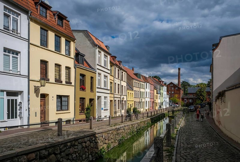 Wismar, Mecklenburg-Western Pomerania, Germany, renovated old town of the Hanseatic city of Wismar, restored colourful eaves houses at the mill pit, historic canal, streets with cobblestones, old town is an area monument of urban architecture, Unesco, world cultural heritage, in the back the old town mill, Europe