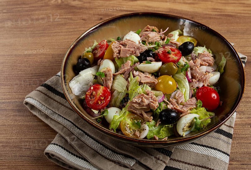 Salad with canned tuna, vegetable salad with quail eggs, lettuce, red onion, cherry tomatoes, olives, keto food, healthy food, homemade, no people