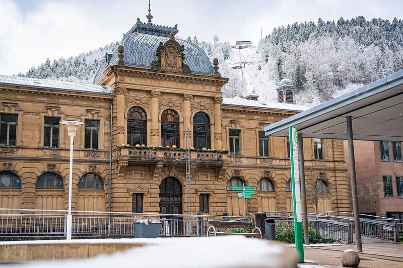 Historic building with snow-covered architecture and surrounding mountain panorama in winter, Bad Wildbad, König-Karls-Bad, Black Forest, Germany, Europe