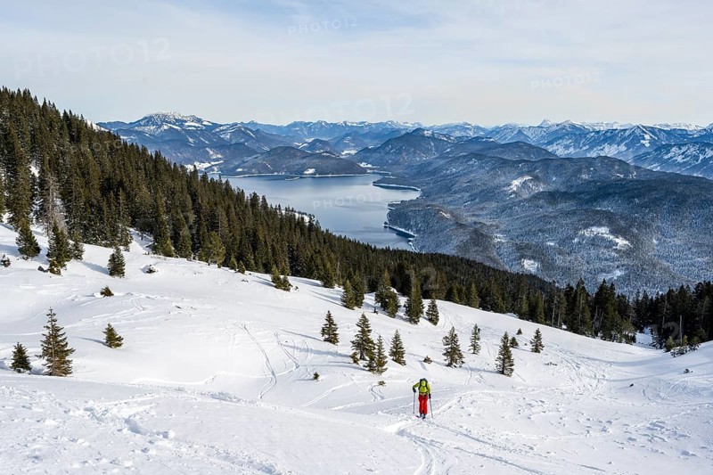 Ski tourers climbing Simetsberg, view of Walchensee, Estergebirge, Bavarian Prealps, Bavaria Germany