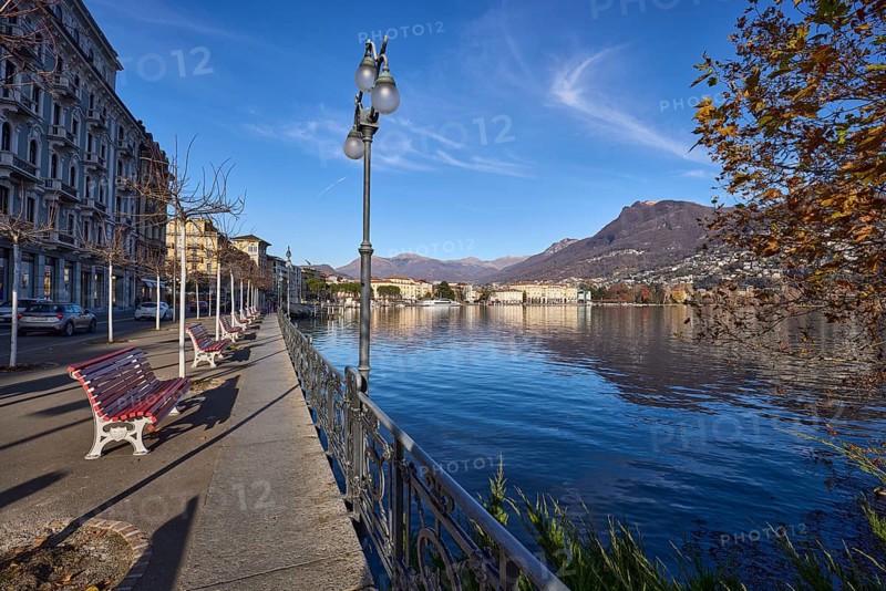 Lakeside promenade, benches, city trees, general development, lantern, blue sky, cirrus clouds, Lake Lugano, street Riva Vincenzo Vela, Lugano, district Lugano, canton Ticino, Switzerland, Europe