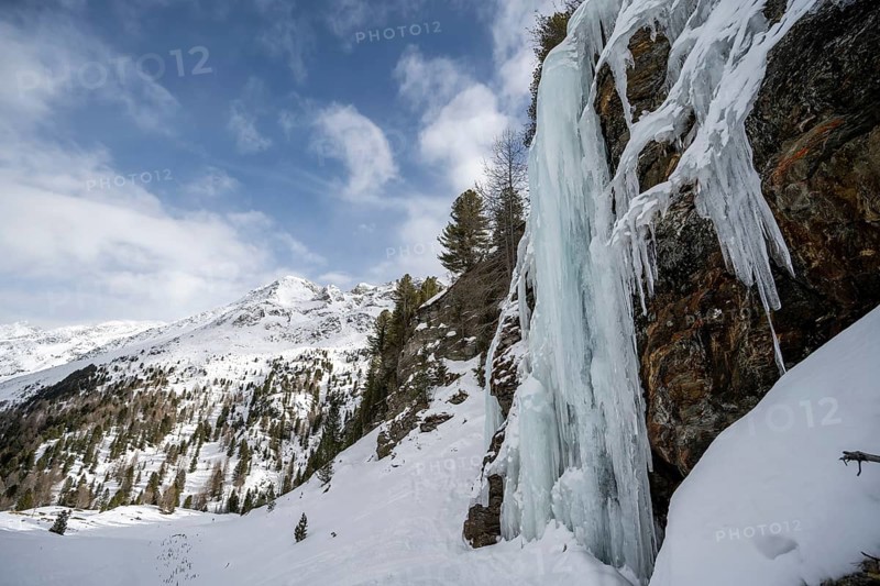 Ice waterfall, icy waterfall on a rock, snow-covered mountain landscape, Ortler Alps, Vinschgau Valley, Italy, Europe