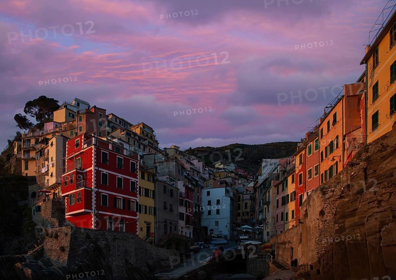 Italy, Riomaggiore colorful buildings overlooking scenic shoreline. Cinque Terre landscapes in Italy on Amalfi Coast, Europe