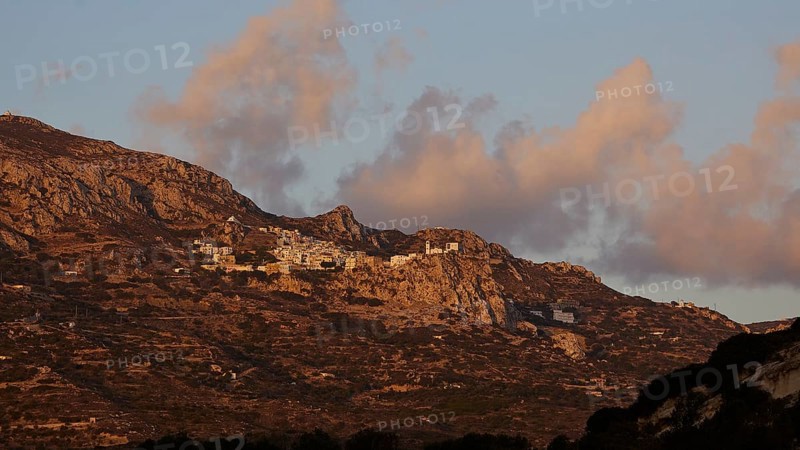 A village on a rocky plateau in a mountain range at sunrise under a cloudy sky, mountain village Menetes, morning light, Karpathos, Dodecanese, Greek Islands, Greece, Europe