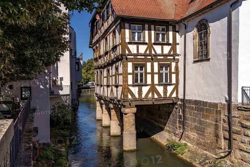Half-timbered hospital building on piles in the water, Forchheim, Upper Franconia, Bavaria, Germany, Europe