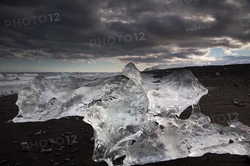 Little icebergs and crushed ice on the black beach at Joekulsarlon glacial lake
