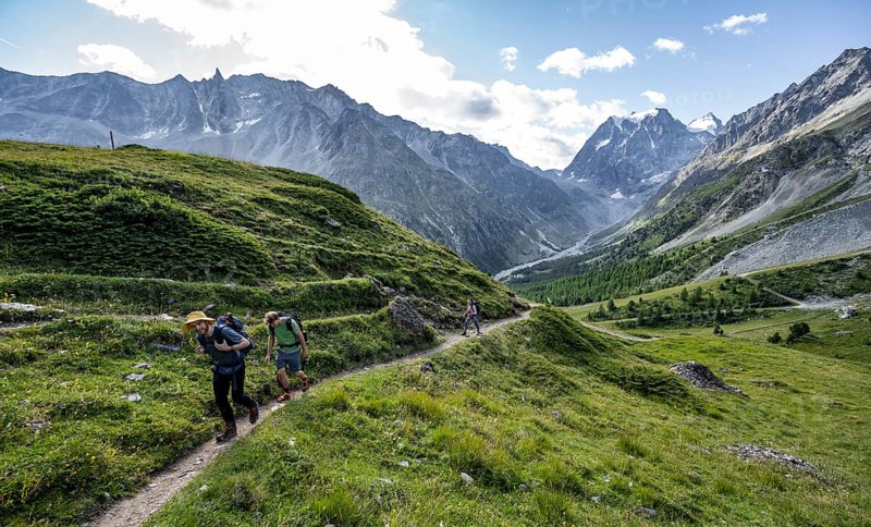 Mountaineer on a hiking trail, mountain landscape near Arolla, behind mountain peak Mont Collon, Valais, Western Alps Switzerland