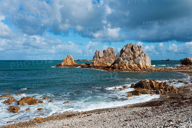 Steep rock formations on the coast with crashing waves and a cloudy blue sky, Plage de Pors Scaff, Plougrescant, Côtes-d'Armor, English Channel, Brittany, France, Europe
