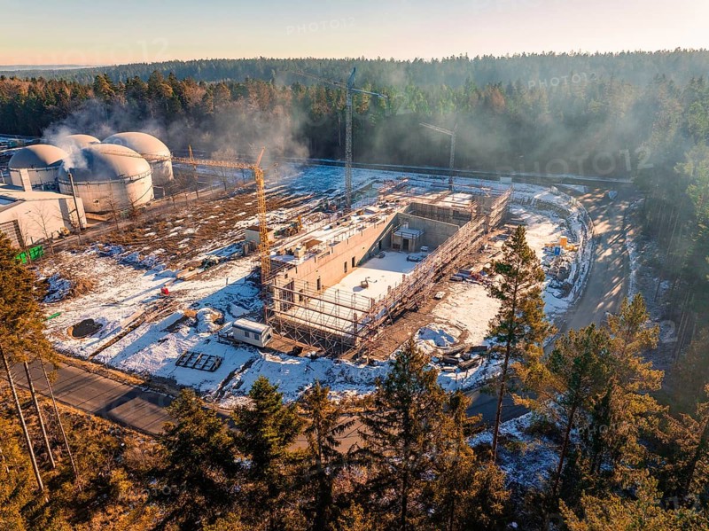 Construction site near domed buildings in the forest, snow-covered and with construction crane, new fire station, Oberhaugsett, district of Calw, Germany, Europe