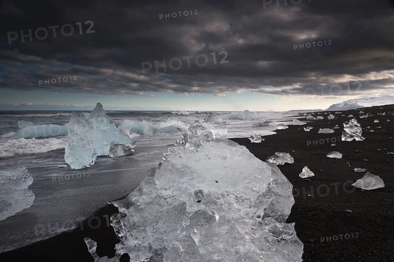 Little icebergs and crushed ice on the black beach at Joekulsarlon glacial lake