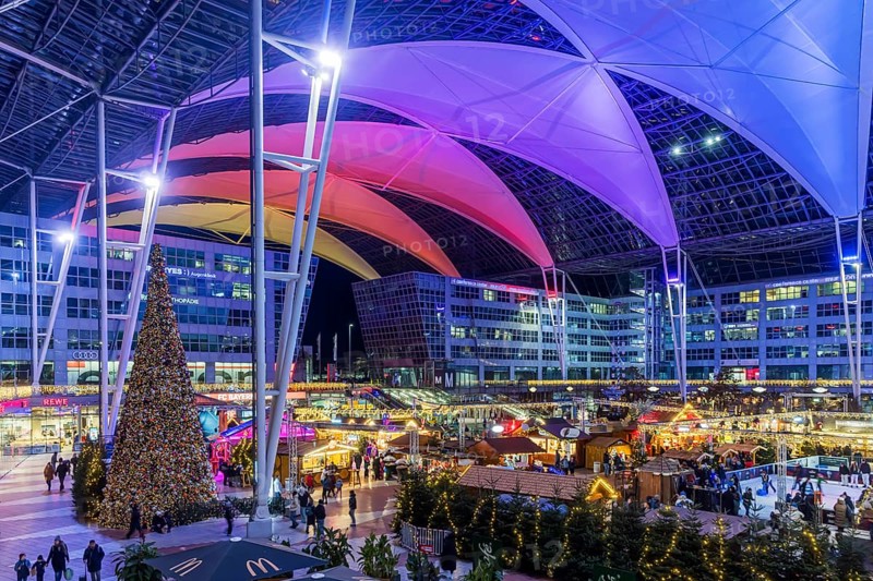 Christmas market at the airport in the evening, market stalls decorated for Christmas in front of the terminal Munich, Bavaria, Germany, Europe
