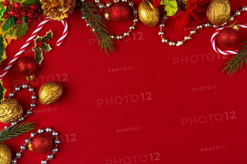 Christmas decoration frame with gold and red elements on a red background, copy room