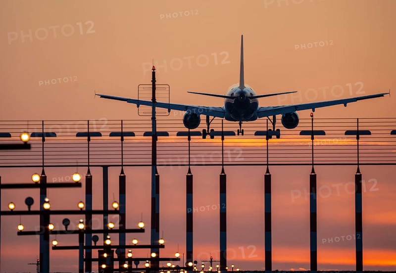 Aircraft approaching the main runway south, 05R/23L, runway lighting, approach aids, at Düsseldorf International Airport, sunset, North Rhine-Westphalia, Germany, Europe