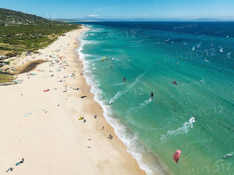 Kite surfers at the Valdevaqueros beach near Tarifa. In the distance the coastline of Morocco. Aerial view. Drone shot. Cádiz province, Andalusia, Spain, Europe