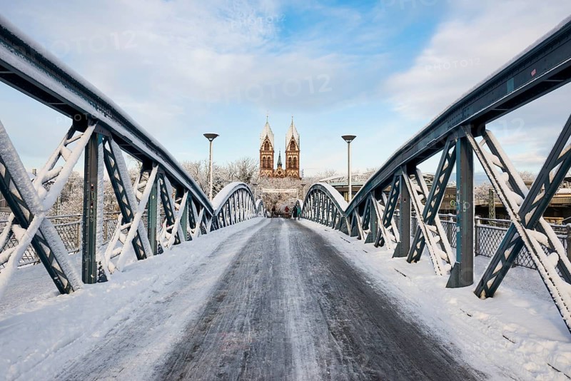 Bridge with snow and ice and cyclists, Blue Bridge and Stühlinger Church, Freiburg im Breisgau, Black Forest, Baden-Württemberg, Germany, Europe
