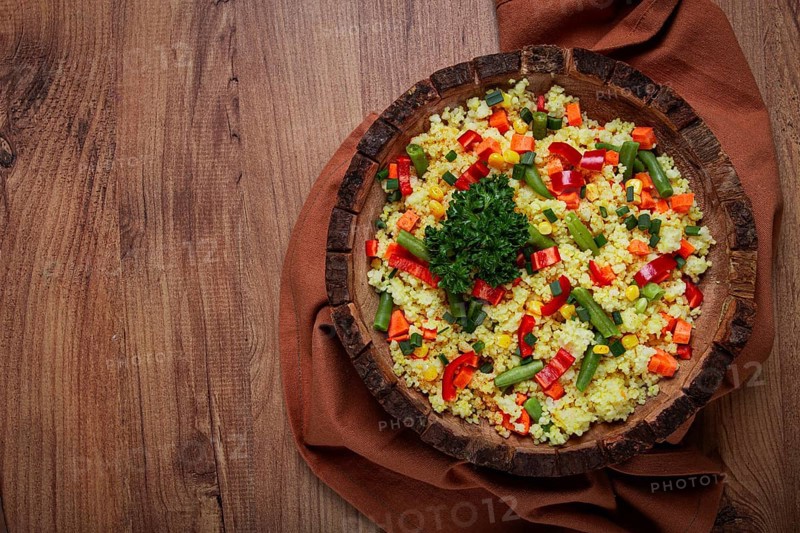 Couscous with vegetables, paprika, carrots, string beans, corn, homemade, top view, no people