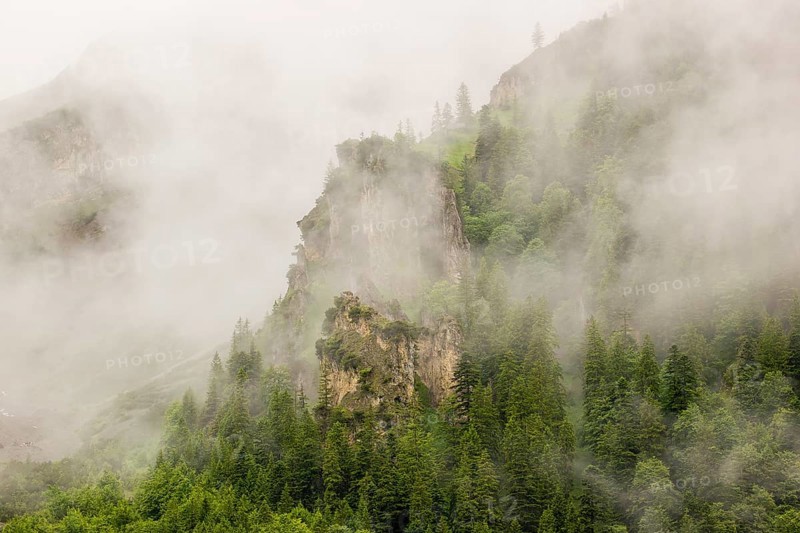 Wisps of mist cover the Karwendel mountains in the Großer Ahornboden nature reserve, Eng Valley, Tyrol, Austria, Europe