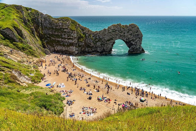 The natural rock bridge Durdle Door and beach of the UNESCO World Heritage Site Jurassic Coast, England, Great Britain